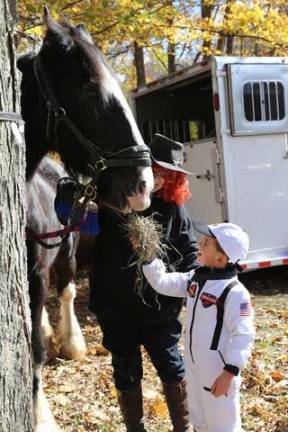 Lucas Kozonasky of Sussex feeds Jack at the DAR halloween party on Sunday.