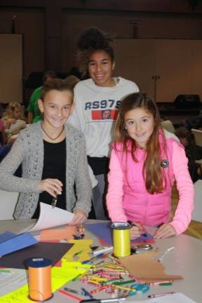 Family Volunteer Day brings out community Left to right, Lily Loewen, 11), Brianna Jones, 15, and Laine Loewen, 9.