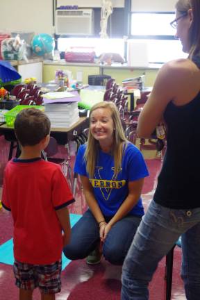 First-grade teacher Miss Erika White is shown greeting a youngster who will be one of her students for the coming year.