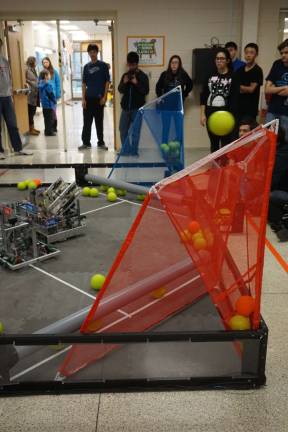 High Point hosts robotics competition Photos by Vera Olinski Competing teams of robots shoot balls into nets at the High Point VEX Robotic competition.
