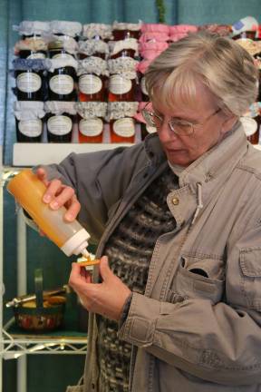 Spring is in bloom in New Jersey Nicki McManus of Wantage samples some gourmet jellies on a Ritz at Springfest.