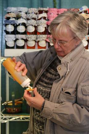 Nicki McManus of Wantage samples some gourmet jellies on a Ritz at Springfest.