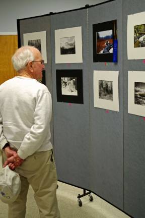 Vince Grey of Vernon is seen perusing the photographs on display.