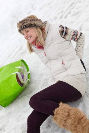 Concussions, breaks on the rise Stock image Woman slipped and injured back on icy street.