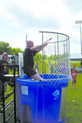 Mike Keating spent much of the day falling in and then climbing out of the dunk tank to help raise money for the Vernon Little League.