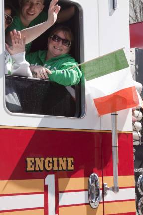 Newton goes green Folks from Vernon Fire Departments E One truck wave to the crowd.