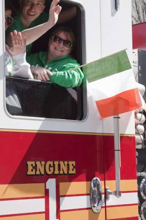 Folks from Vernon Fire Departments E One truck wave to the crowd.