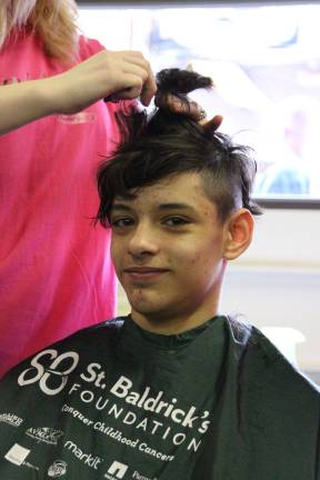 Jarek Cintron of Wantage grew his hair long for his first buzz cut at the Sussex Firehouse for the St. Baldricks fundraiser.