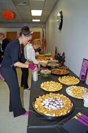 Seniors compete and eat at Halloween party Melissa Wiedbrauk, Vernon Townshipís recreation director helps prepare the dessert tables.