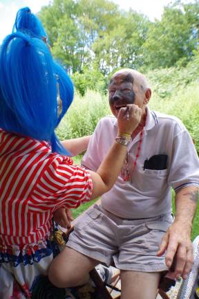 Frank Macherone wanted his face painted with the image of a wolf. Balloon creations and face painting was provided by Kerry Tobin of Highland Lakes, better know as Pixie Pop the Clown.