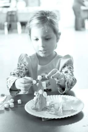 Church holds Christmas craft event Reese Van Benschoten of Wantage adds the final marshmellows to her gingerbread tree creation.
