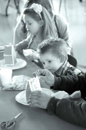 Church holds Christmas craft event Jazmin and Nathan Houghtaling of Sussex pick just the right pieces for their gingerbread houses.