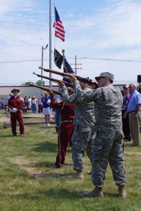 The Honor Guard firing three rounds.