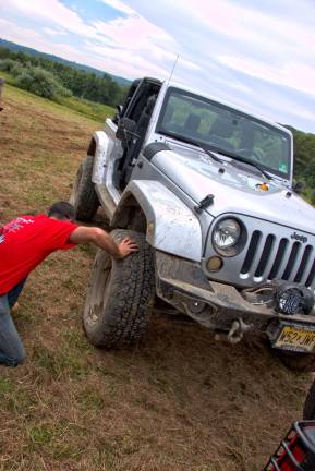 Paul Cooke of Butler checks tires after ride