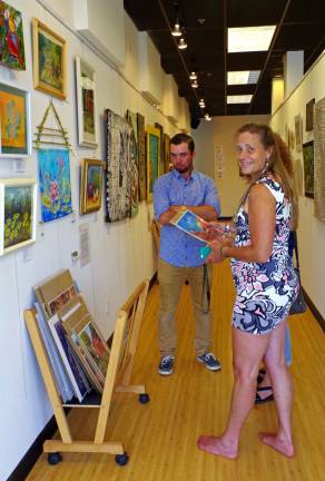 Painter, mixed media artist, and new director of the Skylands Gallery &amp; Studio, Phylis Barfoot of Vernon talks about her artwork during the opening reception last Sunday.