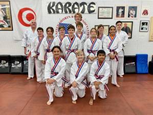In front row, from left, are Melissa Barrett, Harvey Wolverton and Luis Santiago. In middle row, from left, are Rhyleigh Tarrant, Emmett Lawlor, Colby Remington and Teagan Brown. In back row, from left, are Justin Passaro, Bryce VanHaste, Layne Remmington and Lilly Kelso. The instructors are Sensei Tom Shull, Sensei Cody Williams and Sensei Scott Wolven. (Photo provided)