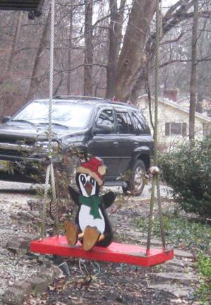 One of John Westermajer&#x2019;s penguin creation swings in the front yard.