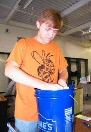 High Point Regional High School junior Nate Stillings, 16 &#x2014;son of co-chairwoman Jane Stillings &#x2014; double-checks that the buckets contain the necessary amount of required flood-bucket items.