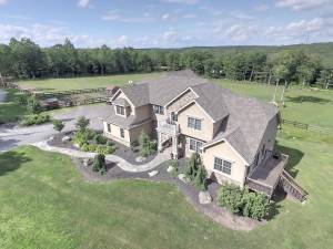 Custom six-bedroom home on equestrian estate with pond