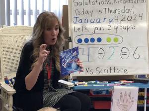 Tara Scrittore prepares to read a story to her kindergarten students at Hamburg School.