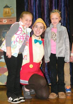 Photo by viktoria-Leigh Wagner From left, Gabriella Moen, 7 and Karli Matthews, 6 of Wantage happy to meet the silly puppet Pinocchio, played by Samantha Evans, 22.