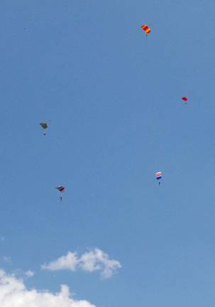 Perfect weather for skydiving ‘Boogie’ Five skydivers can be seen near each other above the south field at Sussex Airport.