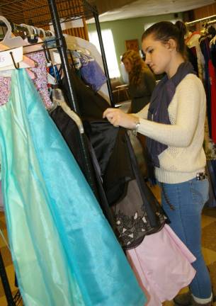 Laura Bartol, 17, of Vernon peruses the beautiful semiformal and prom dresses being given away though the &quot;Project Princess Dress Drive.&quot;