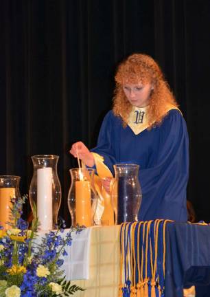 Vernon inducts new National Honor Society members Aileen Bancroft lights the candle for scholarship.