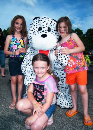 Children pose with Safe and Sound's mascot, Dippy the Dalmatian, at their adoption event Sunday, June 8.