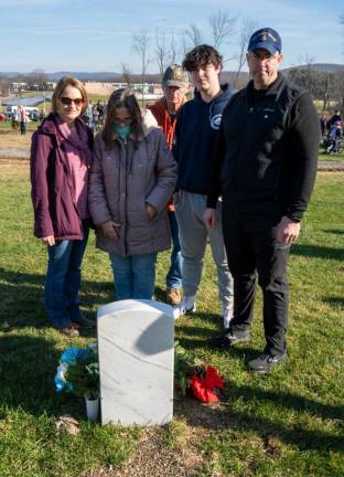 The family of Noah Michael Leyman stand in front of his grave. Leyman, formerly of Hampton Township, died in a highway crash in June at age 22 while serving in the Air Force.