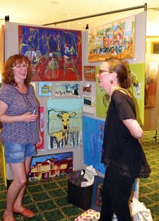 At left, last year&#xfe;&#xc4;&#xf4;s Featured Guest Artist Brenda Decker of Lake Stockholm shares a laugh with fellow artist Stephanie Roth. Some of Roth&#xfe;&#xc4;&#xf4;s work is behind them.