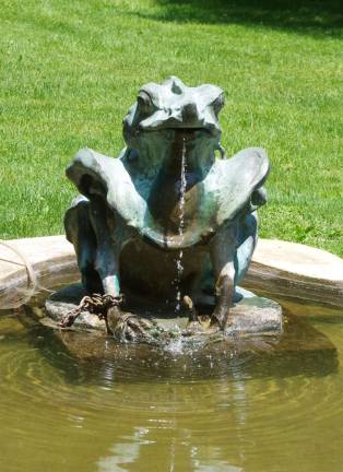 One of the numerous fountains at Meadowburn Farm is reflected in the pool below.