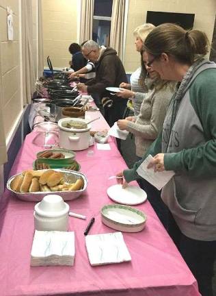 Church holds chili cookoff Table with 14 chili entries.