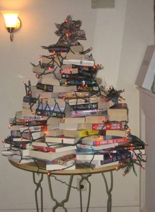 A festive Christmas tree made of books decorates a room at the bookstore.
