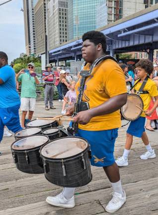 Happy Birthday America! Little Known but Lively 4th of July Parade Wows Lower Manhattan And the Big Man joined the band! Sweat soaked drummer from the Factor Marching Band of Vernon, NJ keeps the rhythms going at the 4th of July parade’s end at South Street Seaport.