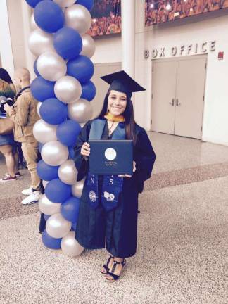 Bria Speziale, of Vernon, graduated from Kean University in May 2015. Here, she holds her degree.