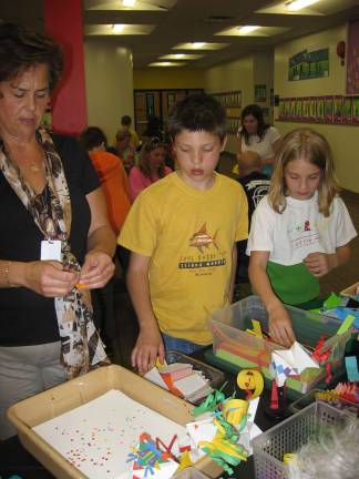 Cedar Mountain holds fourth-grade family art night Pictured from left, second-grade teacher Laura Merck, and fourth-grade students, Tyler Hammerstedt and Savannah Koller.
