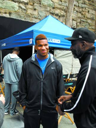 Photo by John Church Eric Ebron Jr. (left), a tight end with the University of North Carolina, talks with his father, Eric Ebron Sr., during a break in the filming.