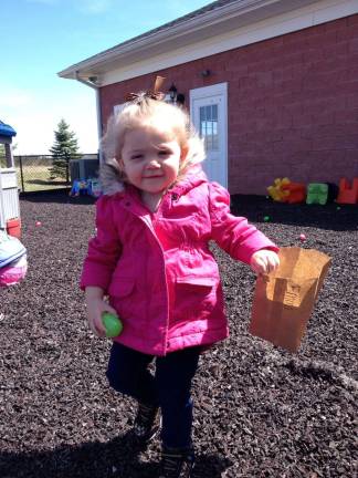 L'il KEEPers celebrate Easter, spring Emma hunts for eggson outside on the playground.