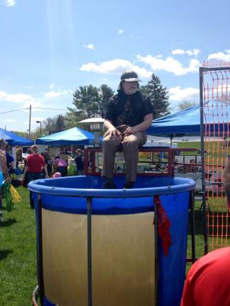 A fun-spirited volunteer got dunked many, many times as children gleefully threw a ball at a bulls-eye. If the ball hit it, into the tub he went.