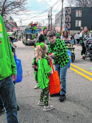 A boy hands out candy during the parade.