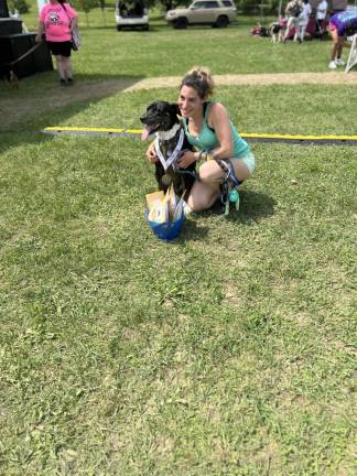 Dogs have their day Bella, posing with owner Allison Koenigsberg, took first place in the peanut butter eating contest.