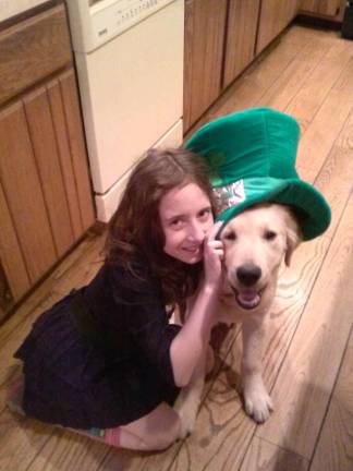 Cathy Leote of Greenwood Lake, N.Y. &quot;Irish step-dancer Tyler and 5 month old Golden Retriever Biscuit celebrate Biscuit's first St. Patrick's Day.&quot;
