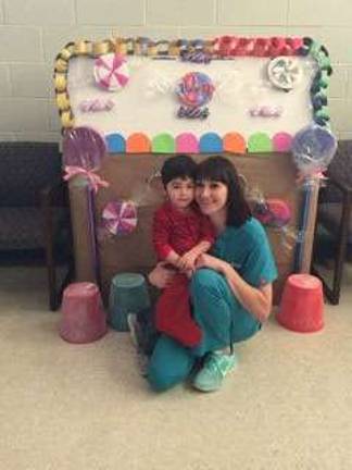 Declan and mom, Meghan, wait to visit with Santa.