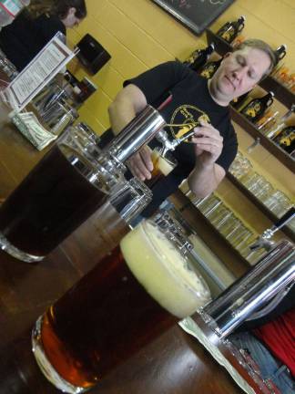 Angry Erik grand opening a hit, despite snow Erik Hassing pours samples of Ravol American amber ale and three-ball porter.