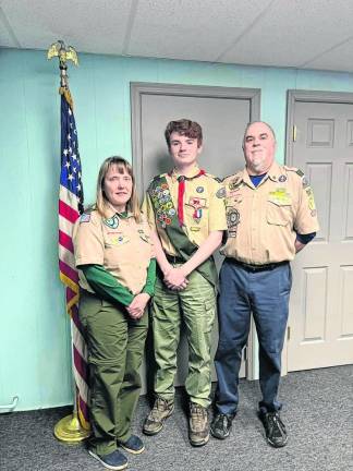 From left are troop leader Carrie Hammerstedt, Dion Rolando and troop leader John Forrest.