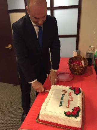 President and CEO of Susse Bank, anthony Labozzetta cuts the cake.