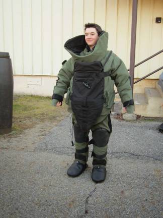 Crew Vice President of Public Relations Stephen Rozek is shown in a bomb suit