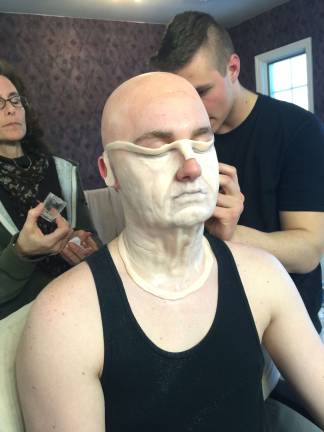 Vernon student learning from makeup masters Brett Schmidt makes up Steve Lohwin as an old man, using a special prosthetic he made out of silicone. His special interest is making aging appliances.