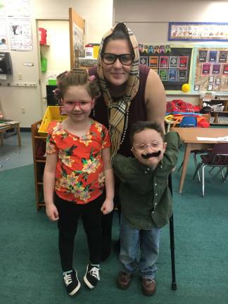Miss Cieloch and Kindergarten students Aubree Clark and Michael Figueroa dressed like they were 100 years old on the 100th day of school.